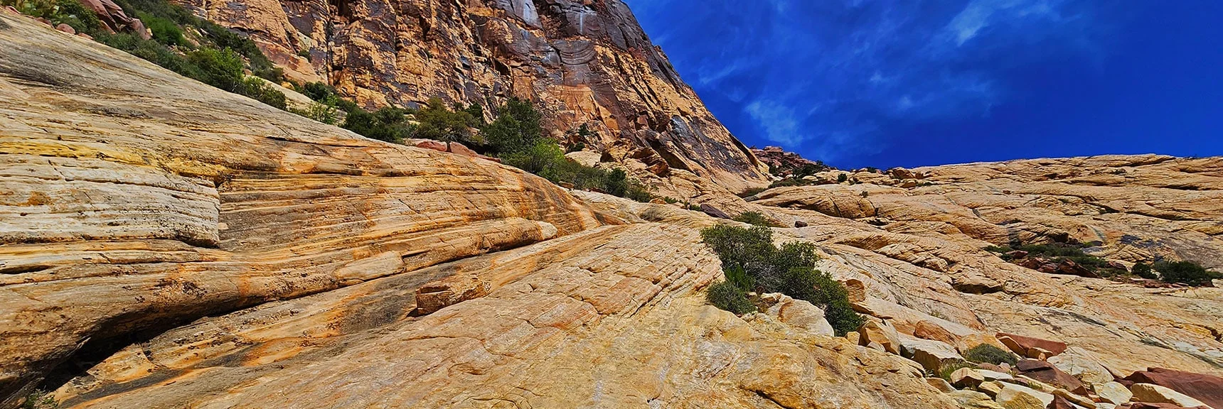 Ascending the Sandstone Slab. Navigate Near the Base of Brownstone Wall (left). | Juniper Peak Summit | Rainbow Mountain Wilderness, Nevada