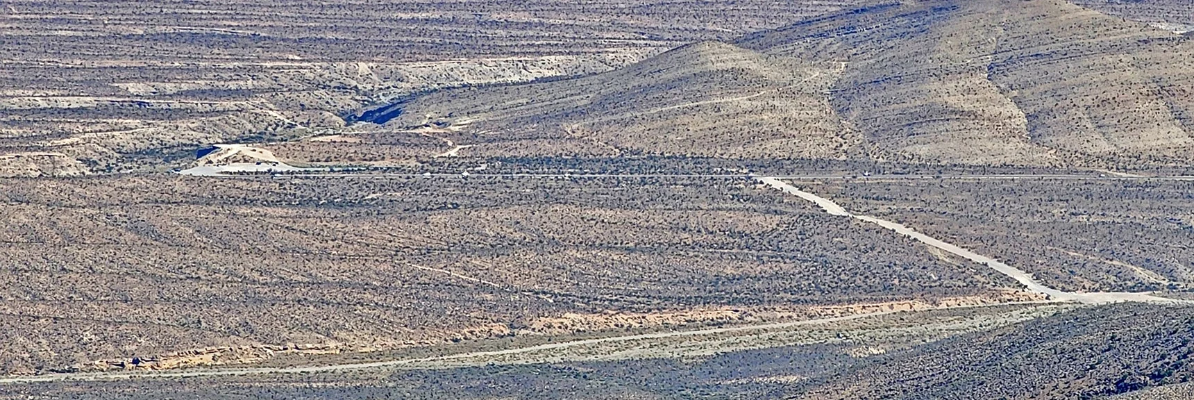 Larger View of Straight Rd Ending at Kyle Canyon Rd. Car Parked in Graveled Area to Left | Kyle Canyon Grand Crossing | Northern Half | La Madre Mountains Wilderness, Nevada