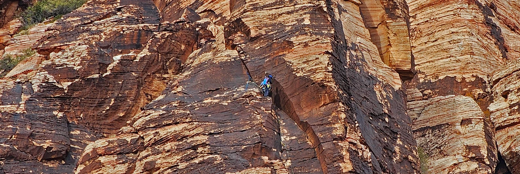 Rock Climber Ascending Juniper Peak's Eastern Cliffs | Rainbow Mountain Eastern Cliffs Rock Climbers | Rainbow Mountain Wilderness, Nevada