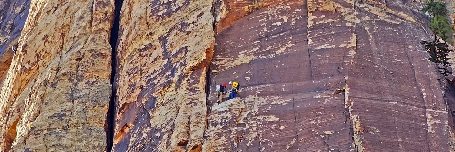 Rock Climbers Resting on a High Narrow Ledge | Rainbow Mountain Eastern Cliffs Rock Climbers | Rainbow Mountain Wilderness, Nevada