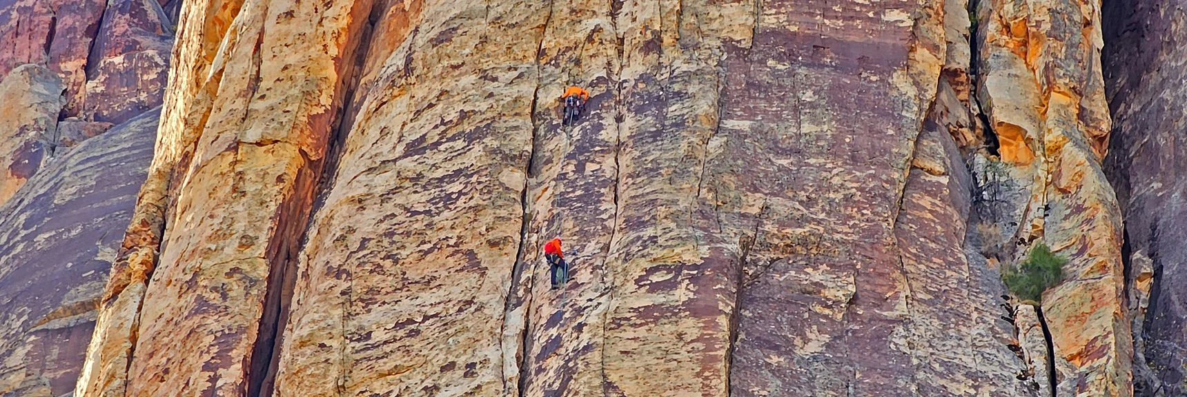 Rock Climbers Ascending Rainbow Mountain's Towering Vertical Eastern Cliffs | Rainbow Mountain Eastern Cliffs Rock Climbers | Rainbow Mountain Wilderness, Nevada