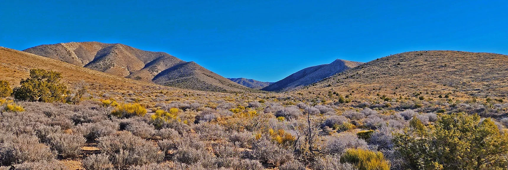 Approaching Canyon Opening. Upper Crest Ridgeline Seen Between Surrounding Hills | Rainbow Mountains Mid Upper Crest Ridgeline from Lovell Canyon, Nevada