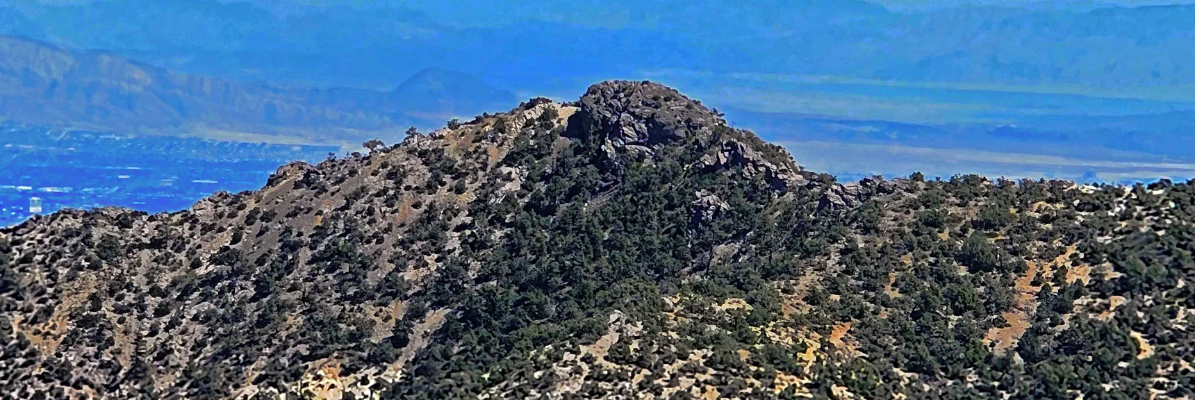 Zoom in on North Peak. Las Vegas Valley Background. | Red Rock Summit | Lovell Canyon & Rainbow Mountain Wilderness, Nevada