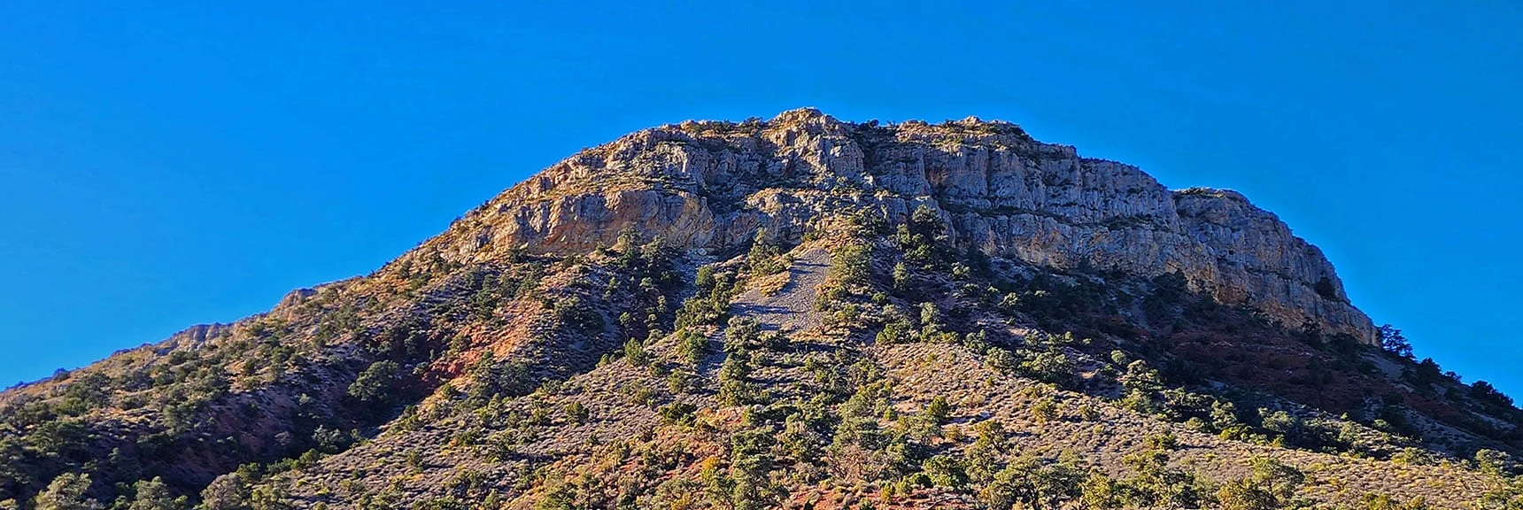 Now Traversing the North End of Landmark Bluff in the Shadow of its Majestic Cliffs. | Landmark Bluff Circuit | Lovell Canyon, Nevada