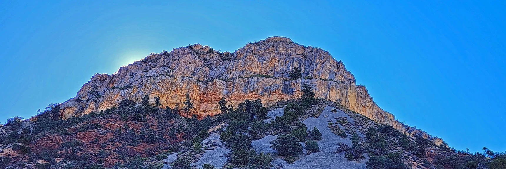 Northern Cliffs of Landmark Bluff Shield the Rising Sun. | Landmark Bluff Circuit | Lovell Canyon, Nevada